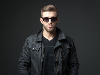 Rahat kıyafet içinde harika görünümlü yakışıklı genç adam portresi.