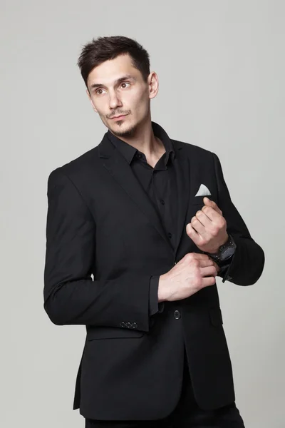 Studio portrait of handsome elegant young man in black  clothes — Stock Photo, Image