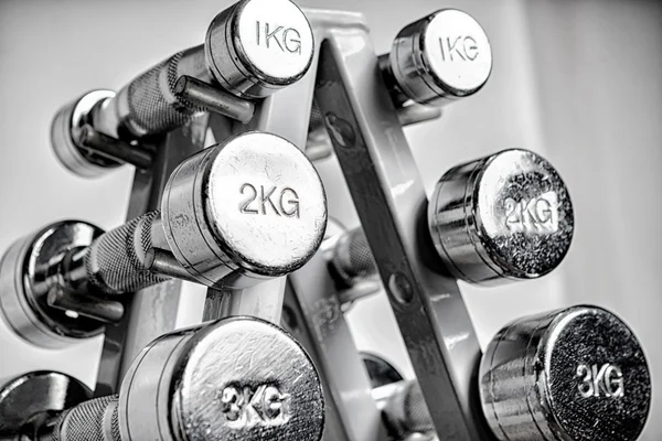 A rack with metal dumbbells. — Stock Photo, Image