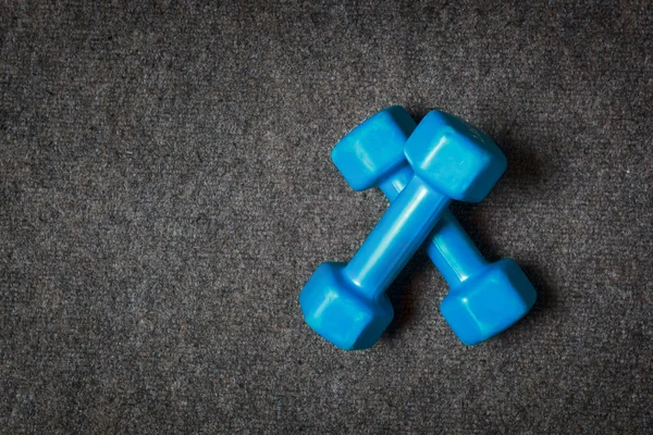 Small dumbbells on floor - fitness concept. — Stock Photo, Image