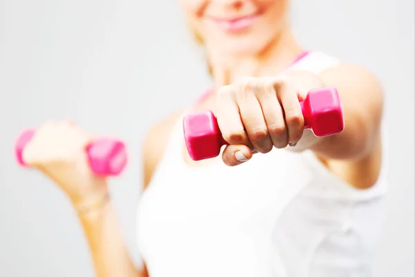 Young woman with dumbbells in her hands. — Stock Photo, Image