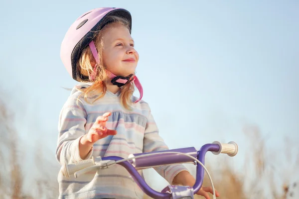 Pequeño niño divertido montar en bicicleta con ruedas de entrenamiento . — Foto de Stock