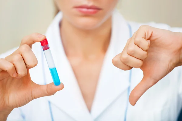 Unhappy young scientist holding samples with bad testing results — Stock Photo, Image