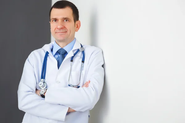 Portrait of confident doctor with crossed hands looking at the c — Stock Photo, Image