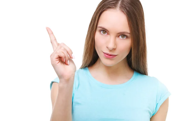 Ung kvinna peka med fingret på kopia utrymme isoleras på w — Stockfoto