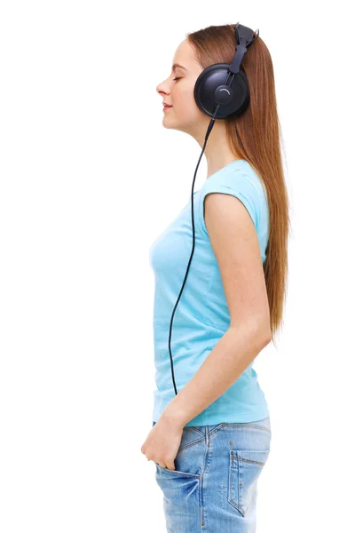 Profil för ung kvinna med hörlurar lyssna på musik - isol — Stockfoto
