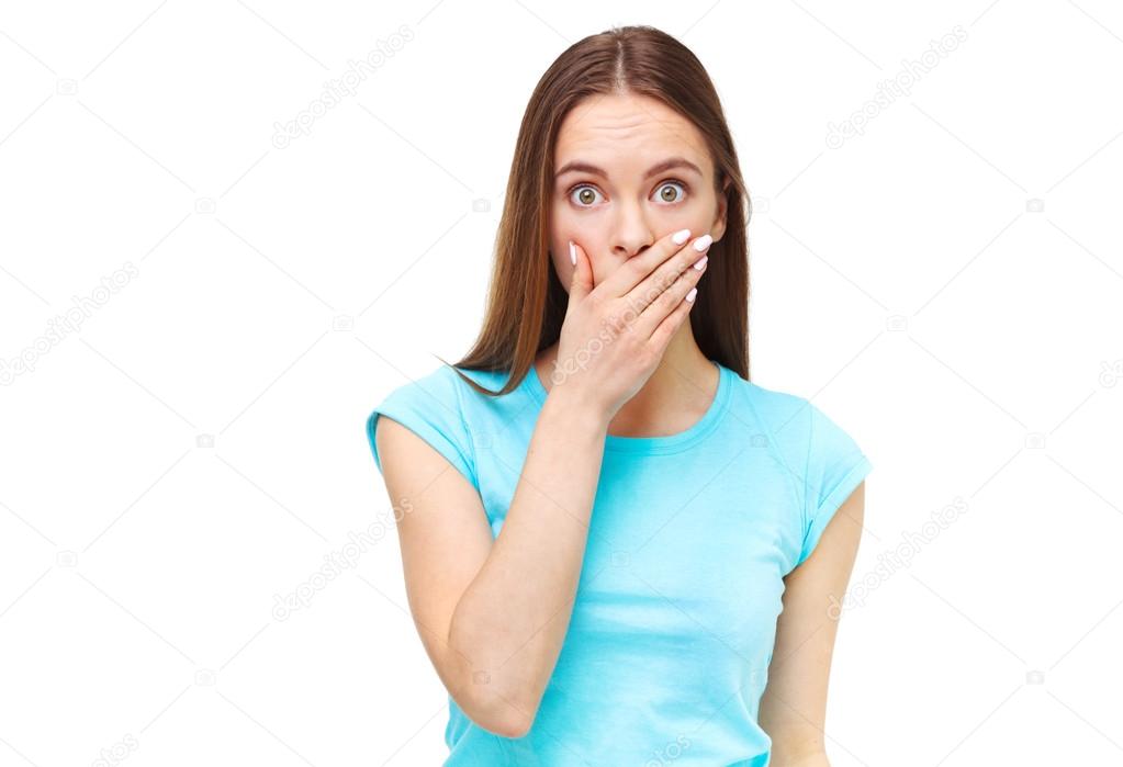 Portrait of young surprised woman isolated on white.