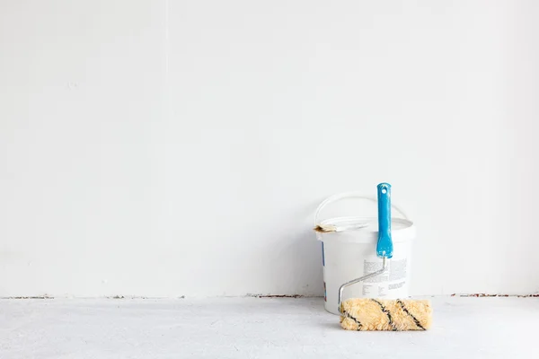 Paint bucket with roller brush on white. — Stock Photo, Image