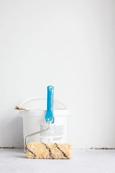 Paint bucket with roller brush on white. — Stock Photo, Image