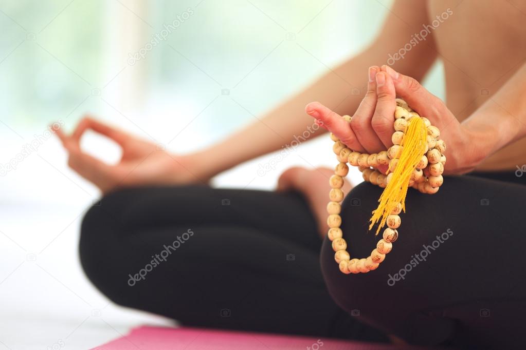 Young woman meditating in lotus pose.