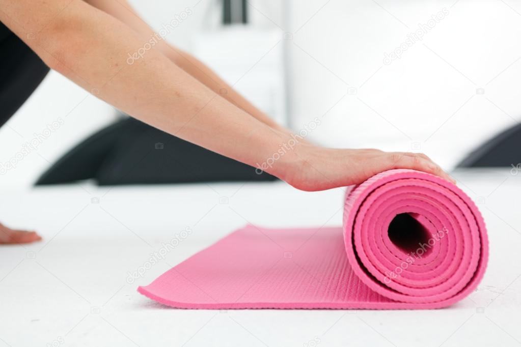 Young woman preparing for yoga.
