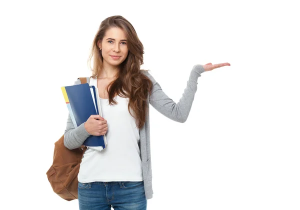 Portrét happy studenta ukazuje něco izolovaných na bílém ba — Stock fotografie