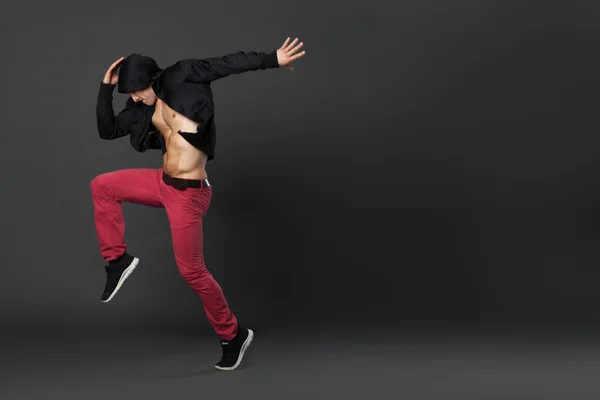 Young male professional dancer dancing in studio.