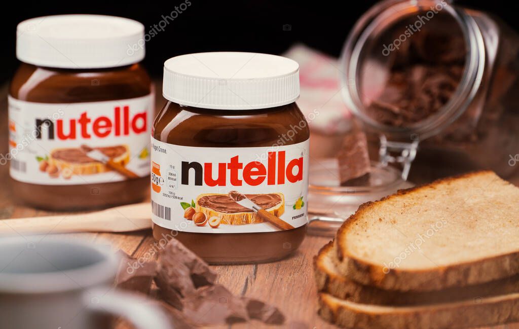 AACHEN, GERMANY - JAN 07, 2021: Pot of Nutella, the popular brand name of a sweetened hazelnut cocoa spread, introduced to the market in 1964 by Italian company Ferrero who celebrates 75 years anniversary in 2021