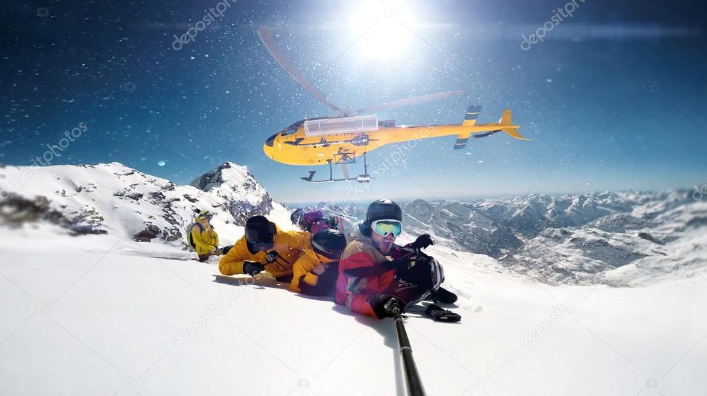 Heli-boarding fun at top of the mountain selfie shot