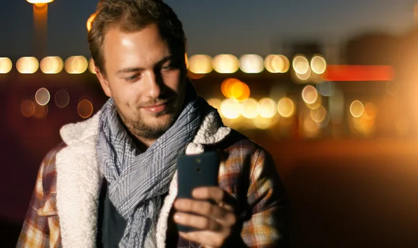 Young man sms texting on smartphone — Stock Photo, Image