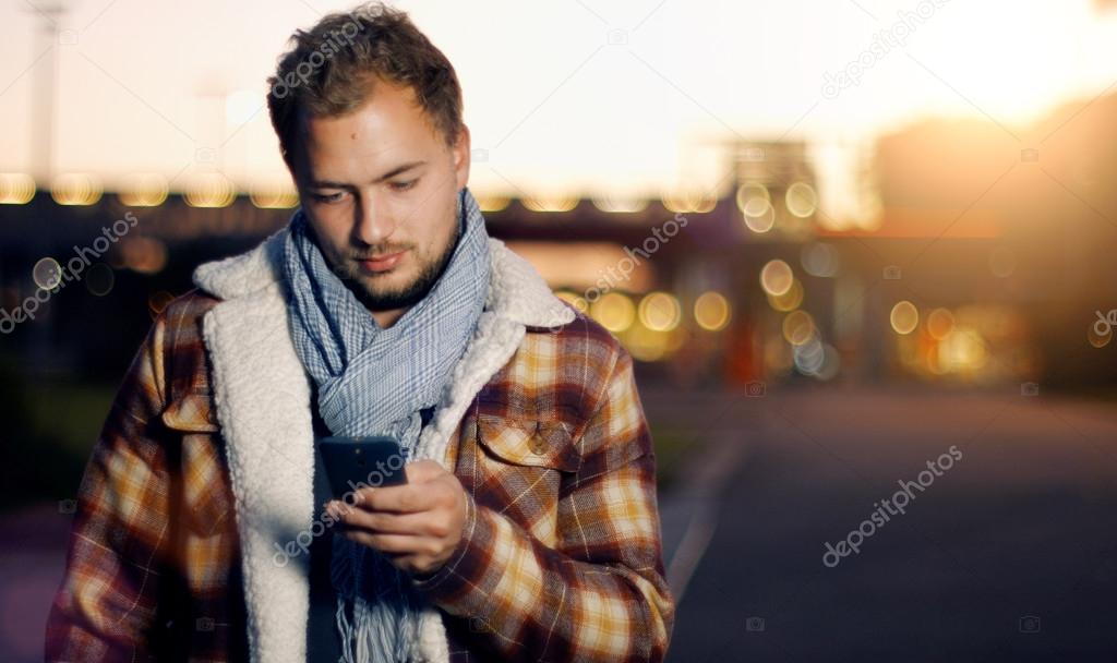 young man sms texting on smartphone