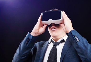 Businessman uses Virtual Reality VR head mounted display clipart