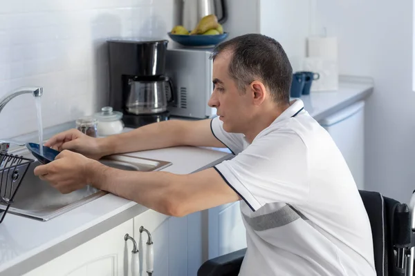 Young Man Disabled Man Wheelchair Washing Dishes Smiling Young Handicapped — Stok Foto