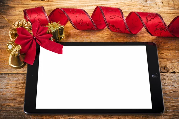 Tablet pc with christmas decorations on wood — Stock Photo, Image