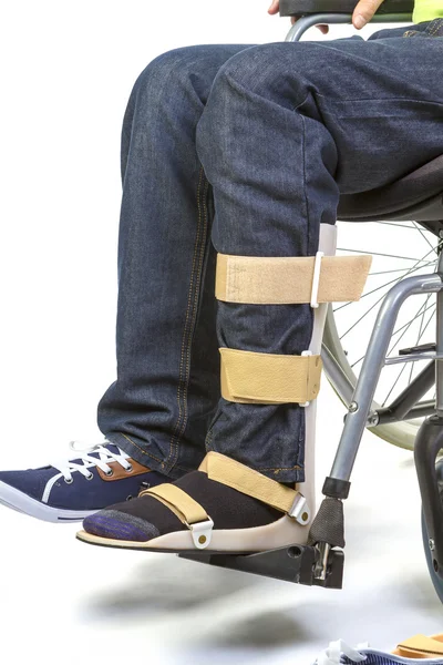 Orthopedic equipment for young man in wheelchair - close up — Stock Photo, Image