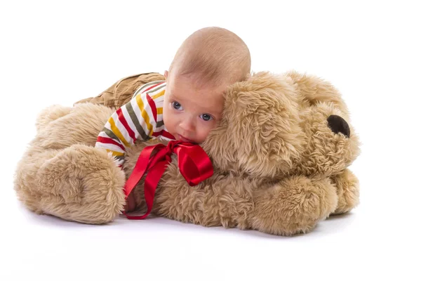 Baby boy over plush dog on white background — Stock Photo, Image