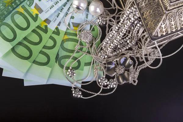 Silver jewelry and euro — Stock Photo, Image