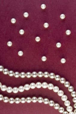 Silver and White pearls necklace on dark red  clipart
