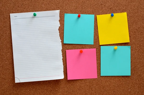 Blank notes pinned into brown corkboard