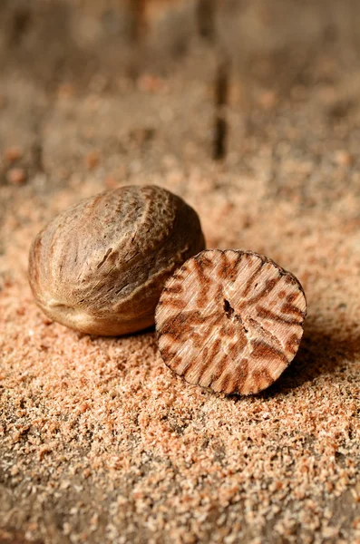 Nutmeg on wooden table — Stock Photo, Image