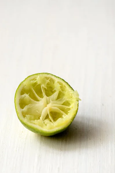 Squeezed slice of lime — Stock Photo, Image