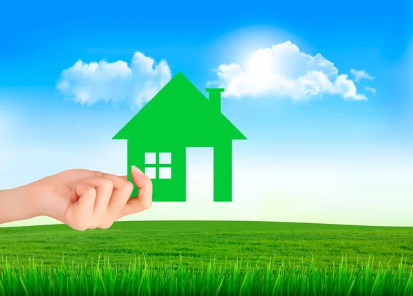 The house in hand on green natural background. Vector. — Stock Vector