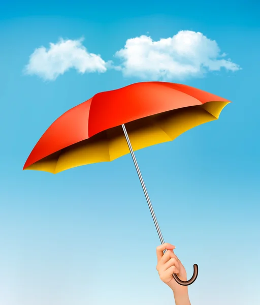 Hand holding a red and yellow umbrella against a blue sky with c — Stock Vector