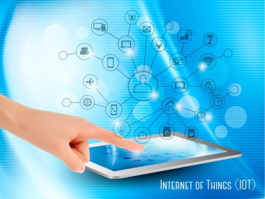 Internet of Things concept (IoT). Hand holding a tablet or smart clipart