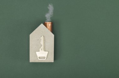 Conceptual house shape with a key and smoke clipart