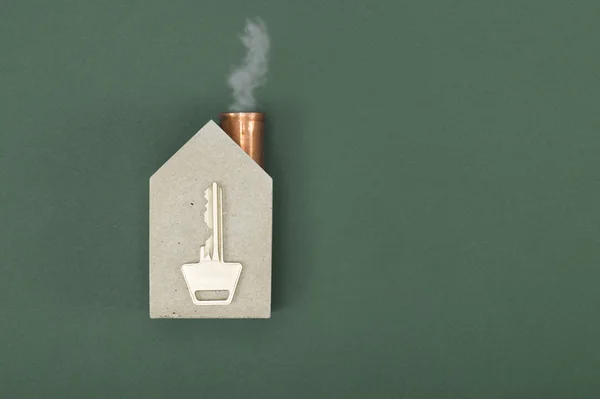 Conceptual house shape with a key and smoke — Stock Photo, Image