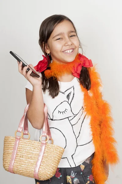 Girl smilling and using a mobile phone — Stock Photo, Image