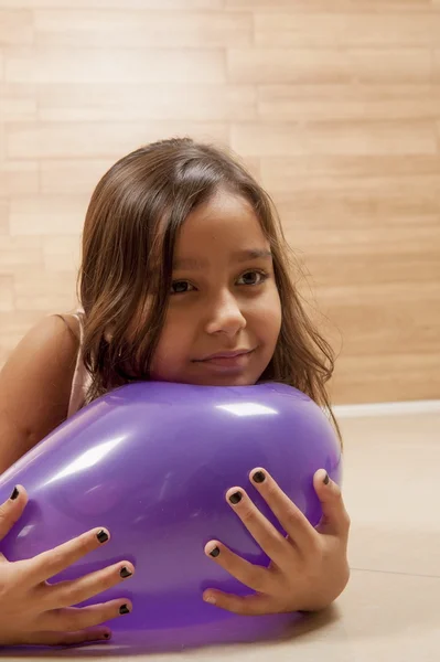 Girl holding a ball and dreaming... — Stock Photo, Image