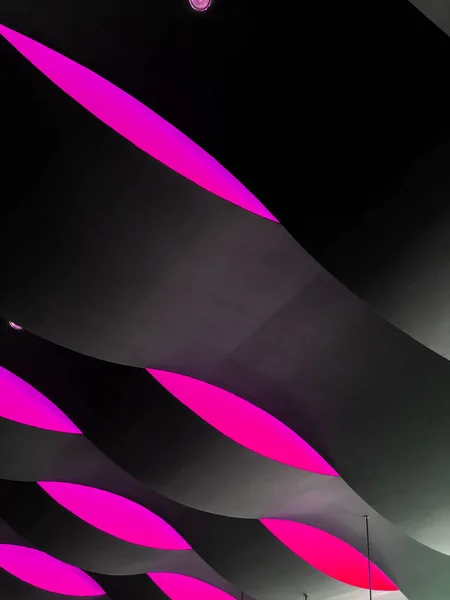 Architectural detail with waving wall pattern, black and magenta