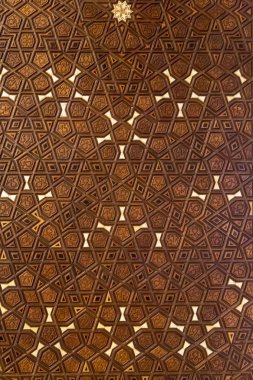 Islamic geometric stars motif pattern, carved on the surface of an old wooden door. clipart