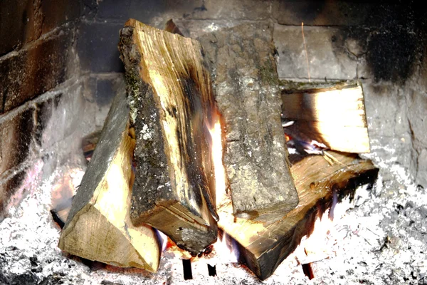 Firewood in the fireplace burning in wintertime — Stock Photo, Image