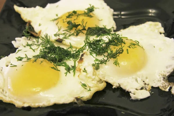 Huevos fritos en el plato y eneldo sobre — Foto de Stock