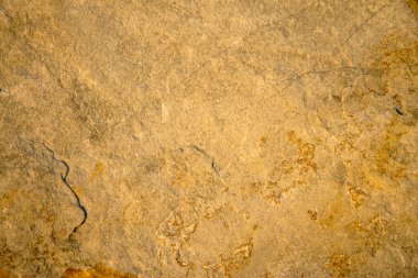 Yatay konumdaki doğal grunge taşı arkaplan dokusu sarı renklerde