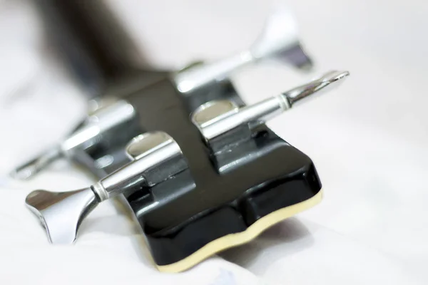 An acoustic bass guitar closeup isolated on the white background