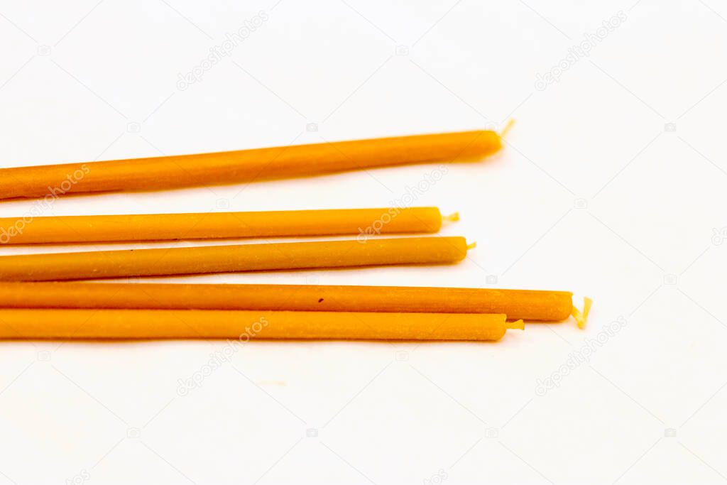 Some church candles laying isolated on the white background