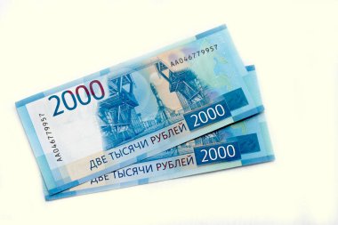 Scattered Russian 2000 rubles new banknotes closeup isolated on the white background