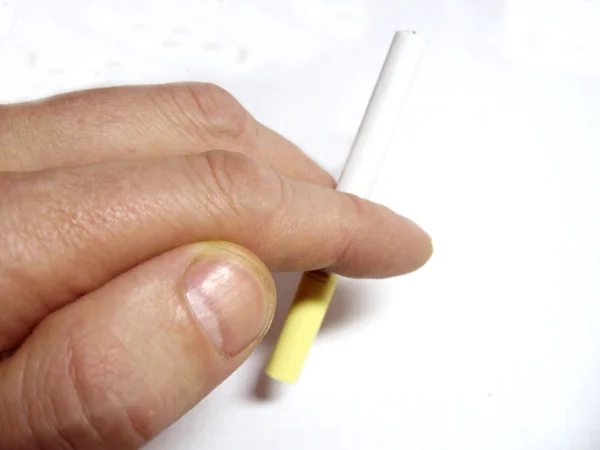 Mans hand holding cigarette in fingers isolated on the white bac — Stock Photo, Image