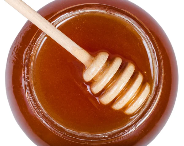 Ovansida av träpinne på glasburk med honung — Stockfoto