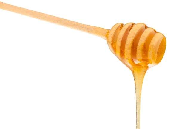 Clear honey flowing down from wood spoon isolated — Stock Photo, Image