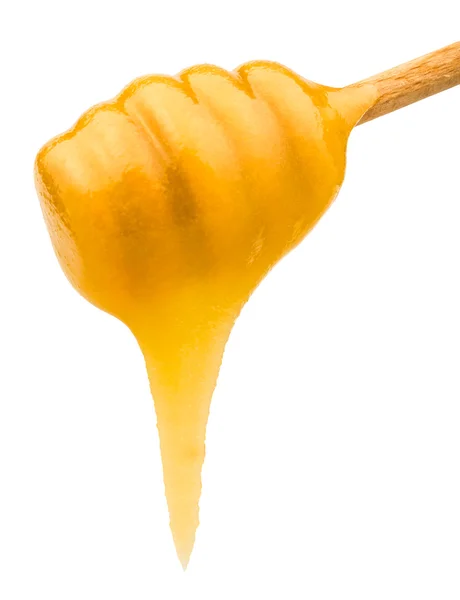 Желтый мед течет из деревянной палки вблизи — стоковое фото